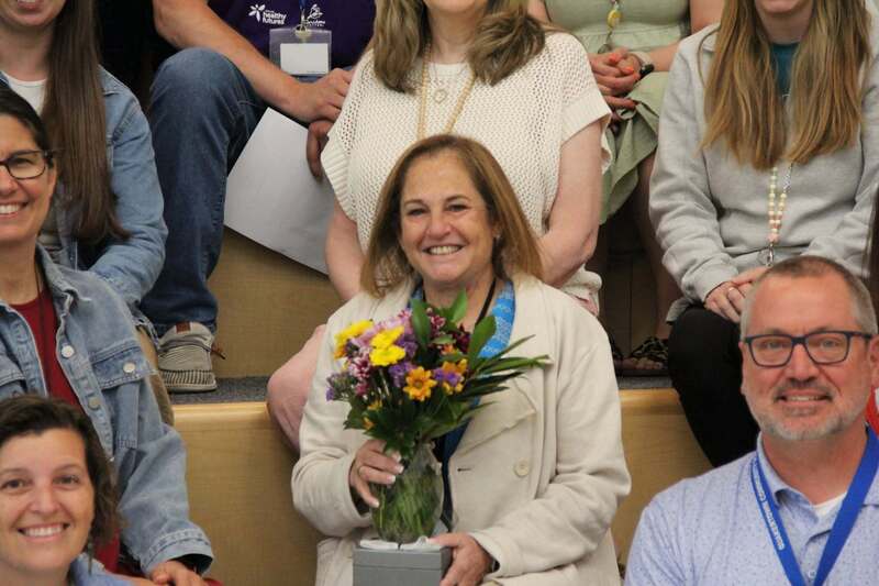 Mrs. Demchick smiles with her flowers