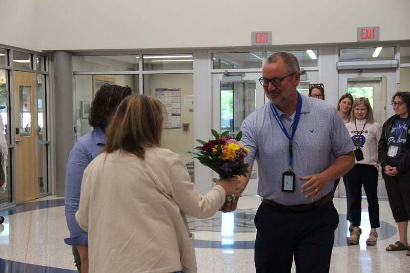 Mr. Godshalk gives Mrs. Demchick flowers