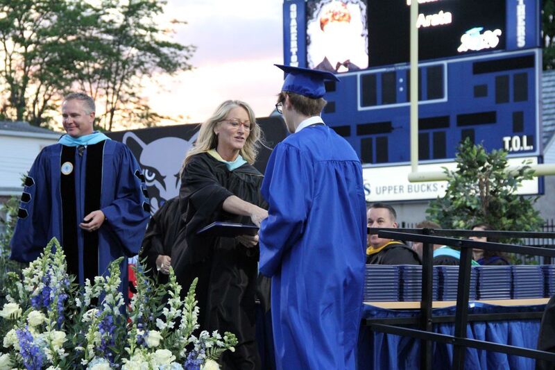 House Principal Helen Conroy  shakes hands with Graduates