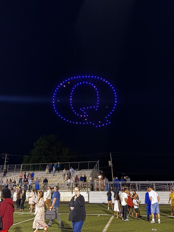 Drones in the sky create a "Q"