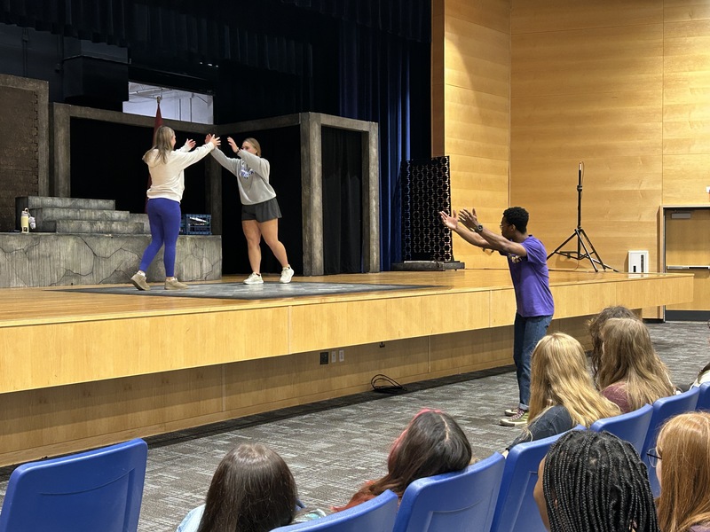 Students perform a stage fall with help from their WillPower instructor
