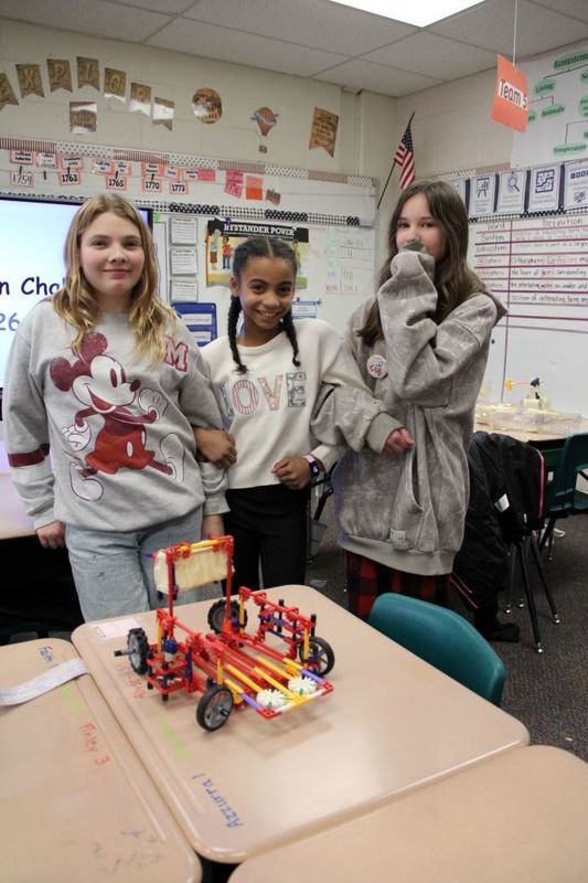 Team "The Three Spokes" pose with their invention