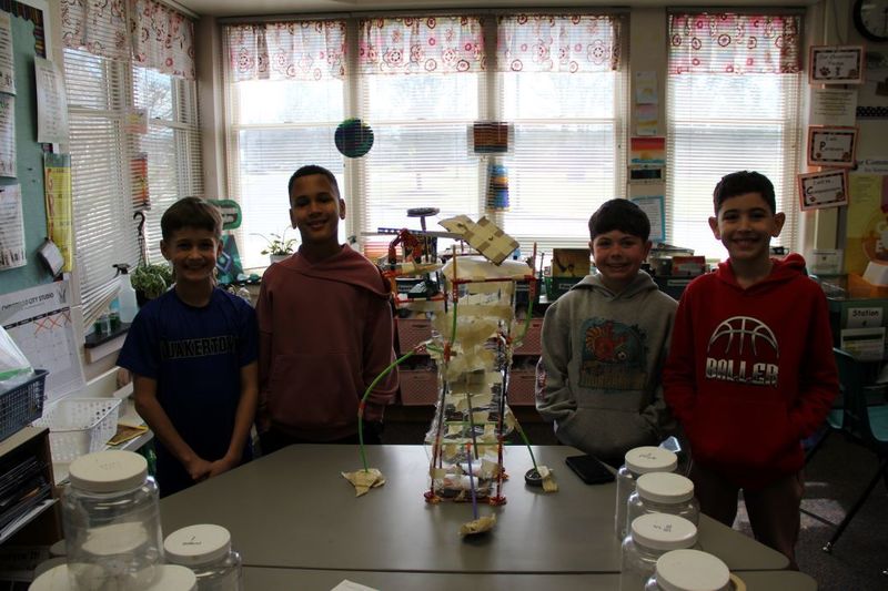 Team "The Garbage Compactors" pose for a photo with their invention.