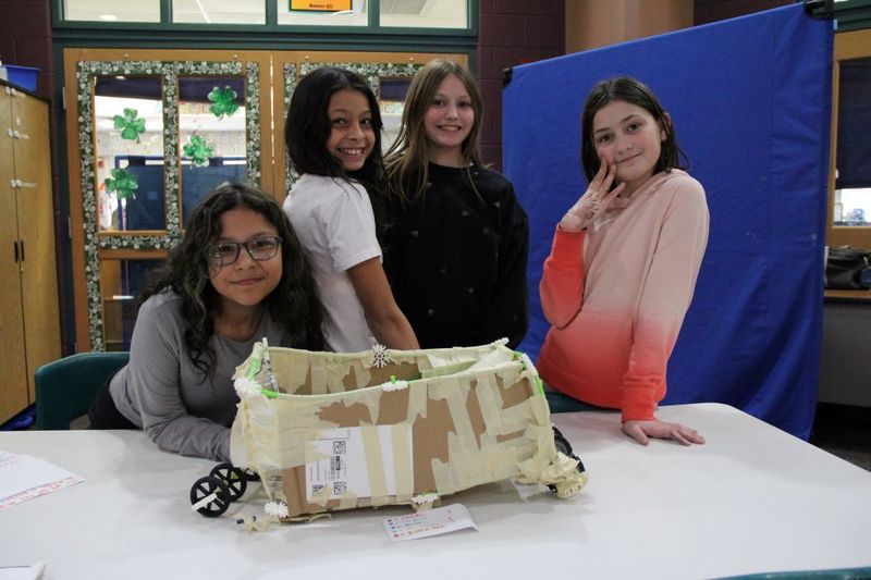 Team "The Miracles" pose with their invention.