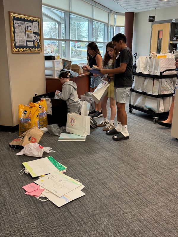 Fifth Grade leaders work together on organizing donations from their service project.