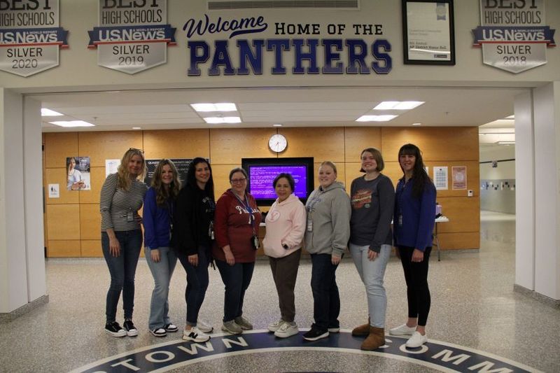 QCHS Paraprofessionals smile for a group photo