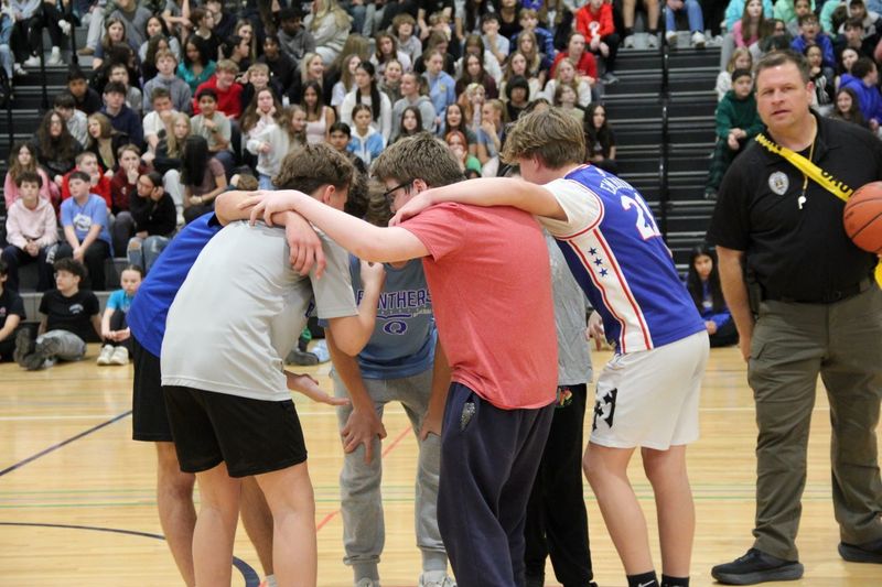 The students huddle to make a plan of attack