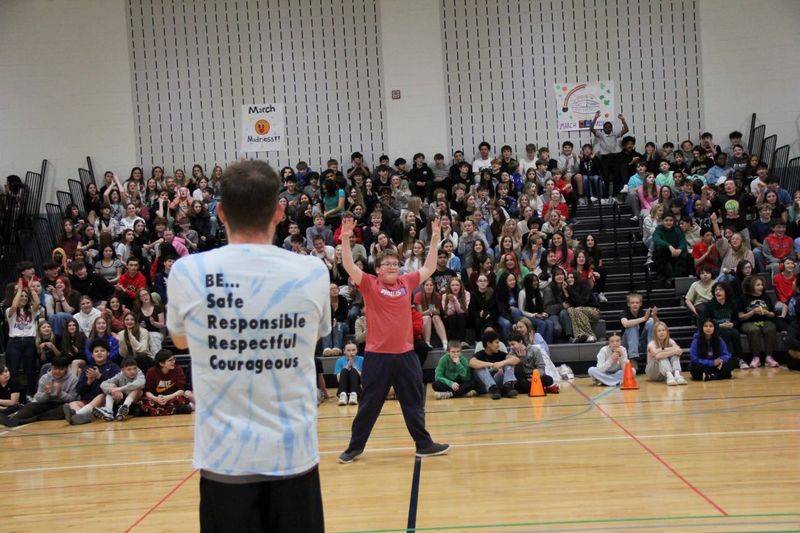 Andew takes a victory lap while the students cheer him on