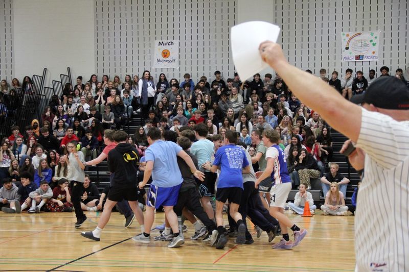 Students gather around Andrew to celebrate