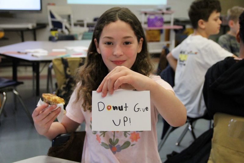 Students writing inspiring cards for their classmates to read during PSSA assessments