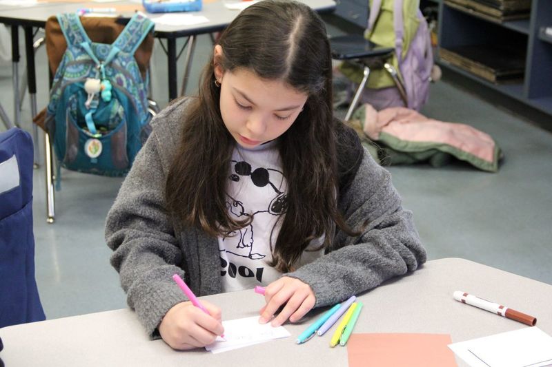 Students writing inspiring cards for their classmates to read during PSSA assessments