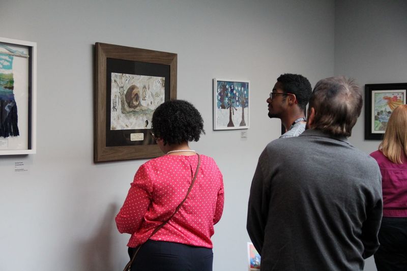 Viewers admire Ms. Clark's artwork