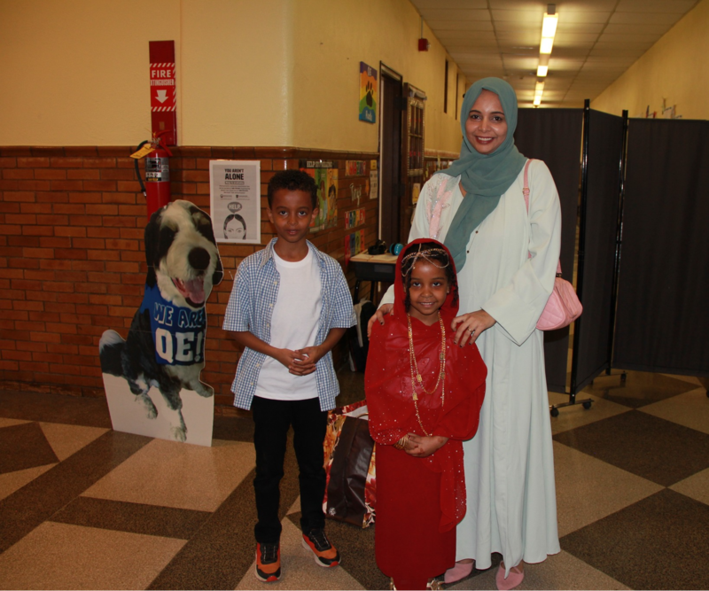 Family smiles for a photo at Cultures day