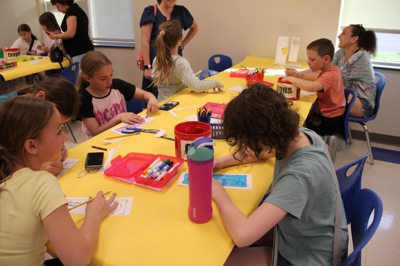 Children color and make vibrant door hangers