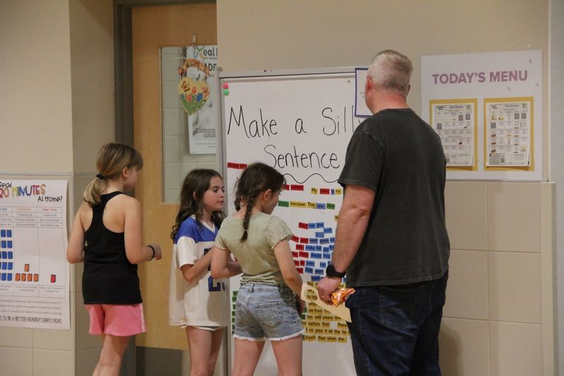 Families play literacy games in the cafeteria