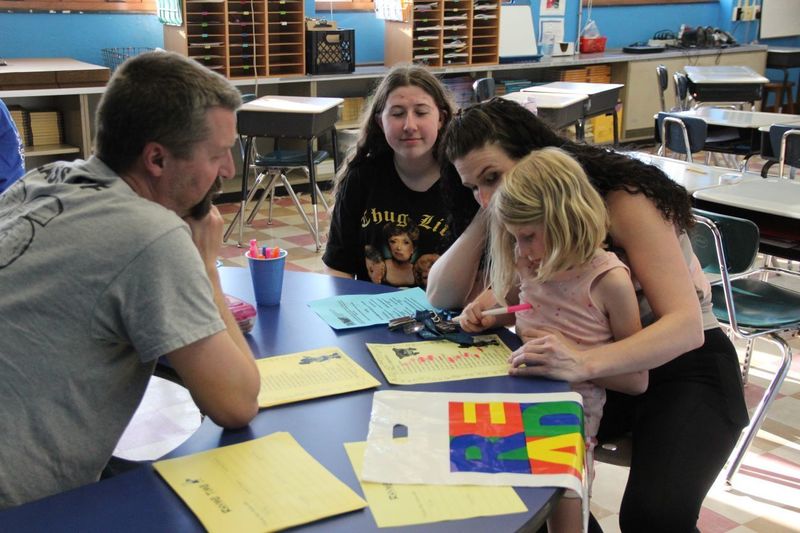 Families working together to complete a writing activity
