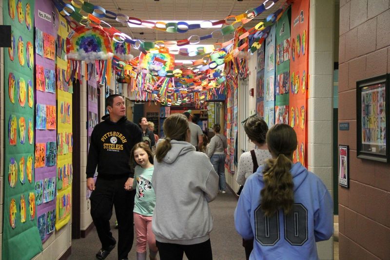 Parents and students look in awe at all the artwork in the hallways of Trumbauersville.
