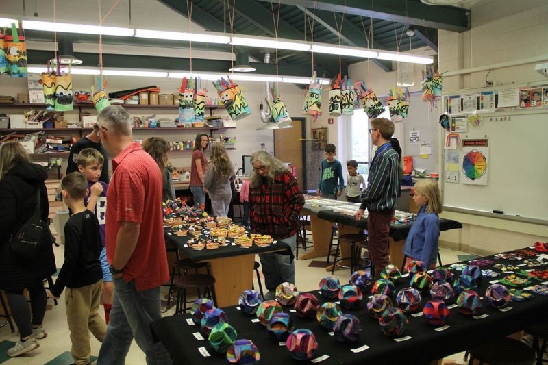 Parents and students look in awe at all the artwork in the art room of Trumbauersville.