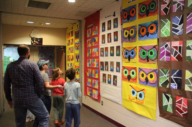 Parents and students look in awe at all the artwork in the hallways of Trumbauersville.