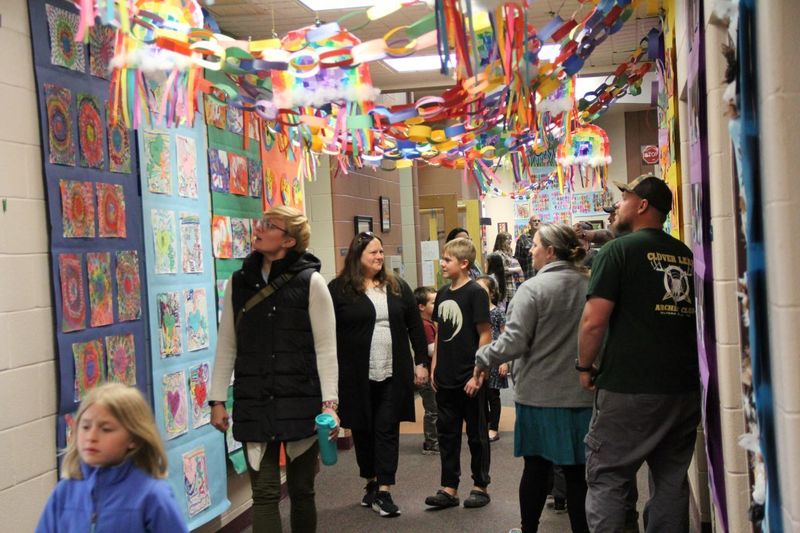 Parents and students look in awe at all the artwork in the hallways of Trumbauersville.