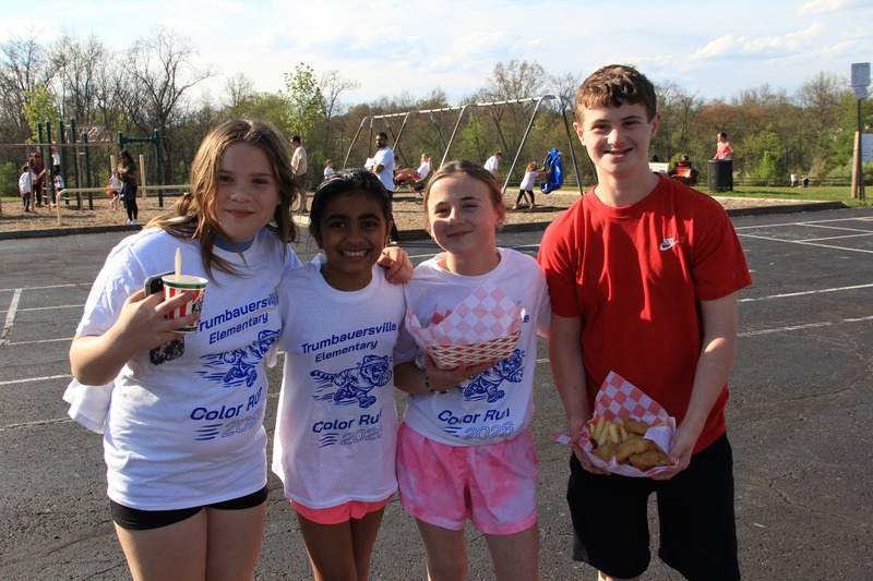Students gather on the blacktop and smile for a photo at the 2026 Color Fun Run