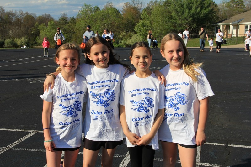 Students gather on the blacktop and smile for a photo at the 2026 Color Fun Run