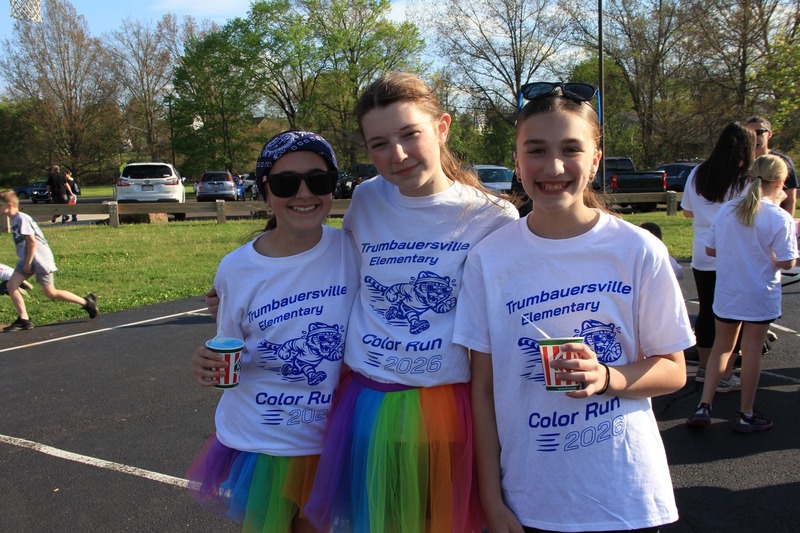 Students gather on the blacktop and smile for a photo at the 2026 Color Fun Run