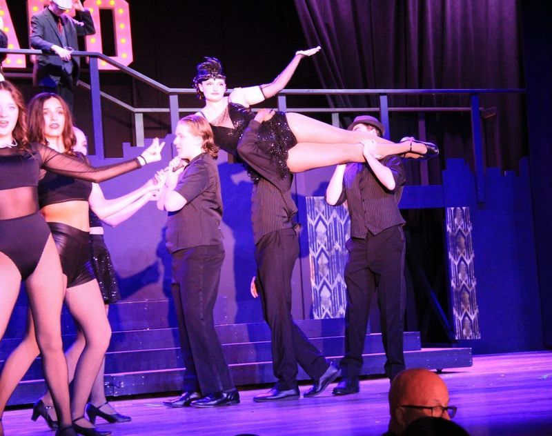 Velma Kelly being lifted by her dancers