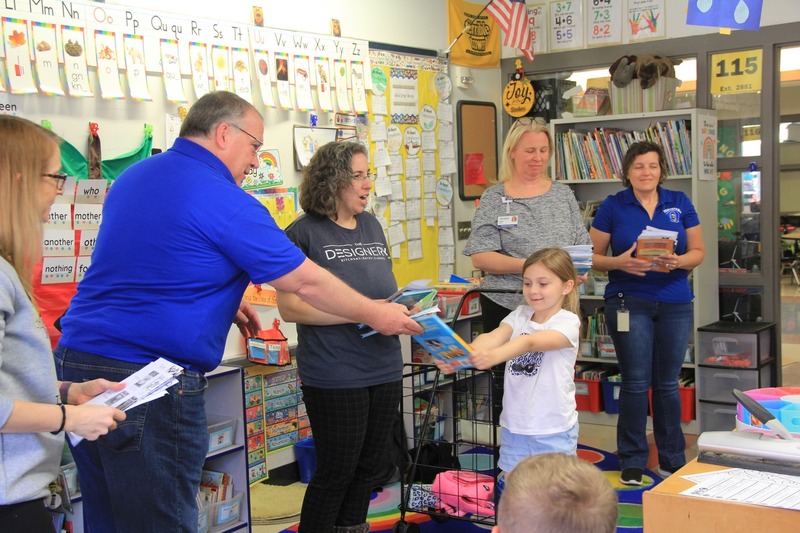 QCEF Members gift books to first graders