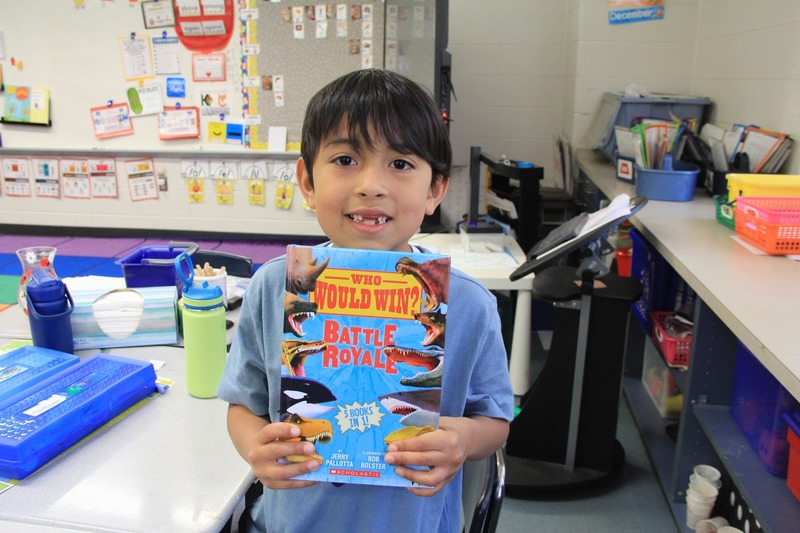 First grader smiles with their new book