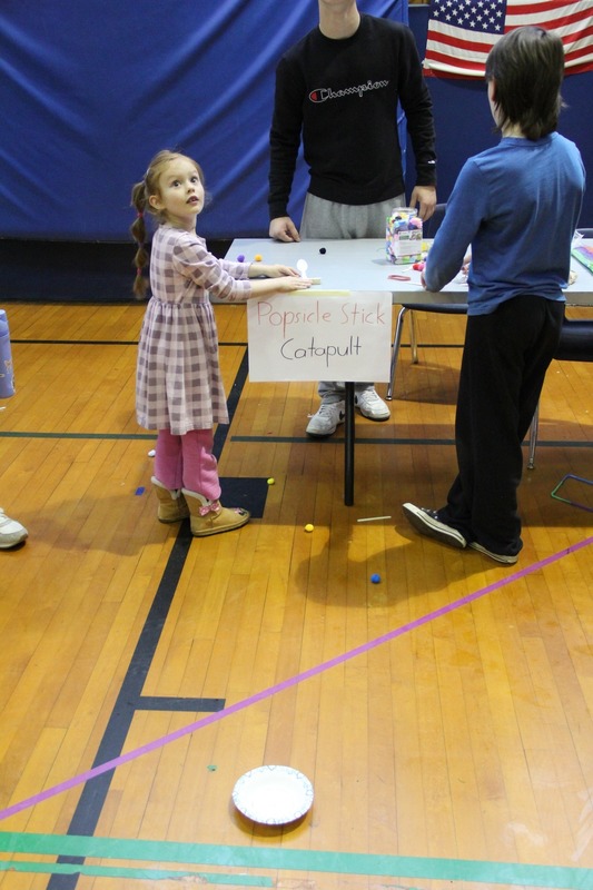 Student see's her puffy ball fly with her catapult