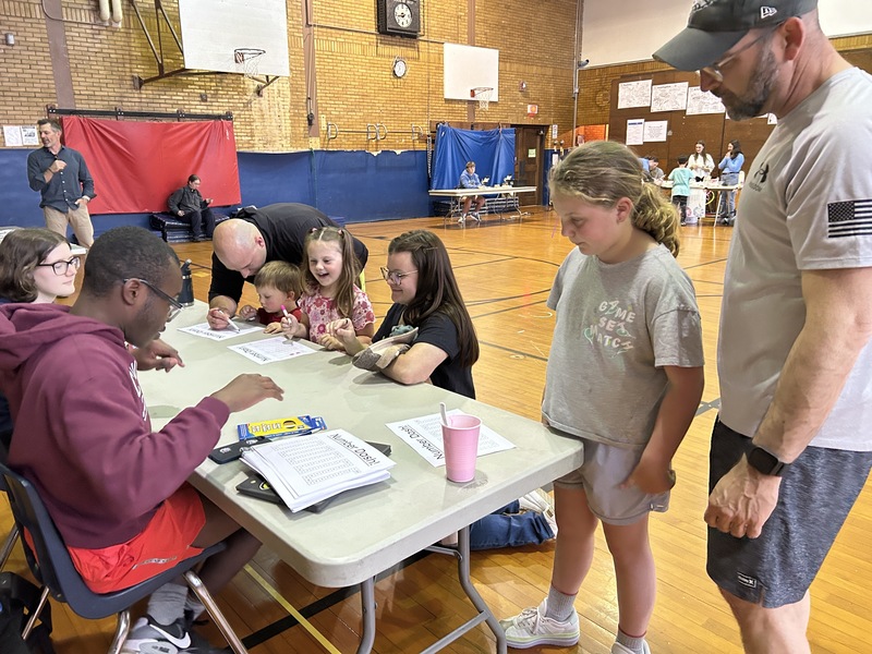 Students line up at the number dash station to play the game.