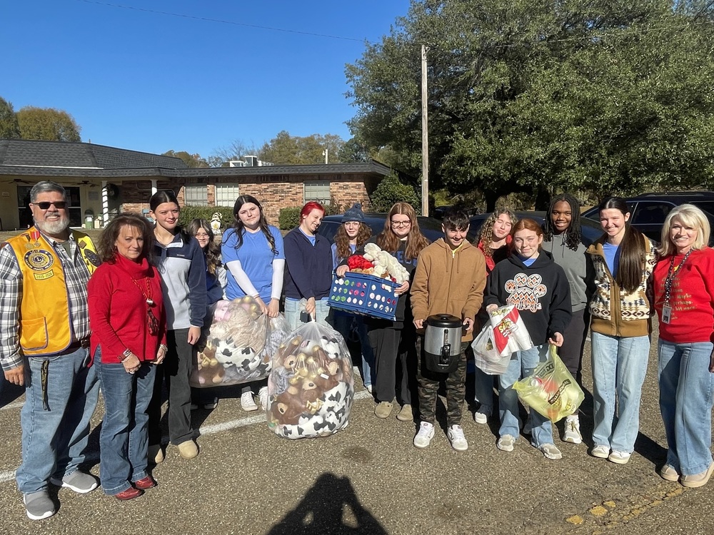 Students from the Queen City High School LEO Club bring gifts to local nursing home