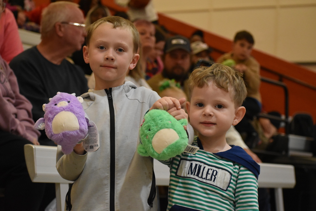 two little boys hold their stuffies ready for Santa Slam