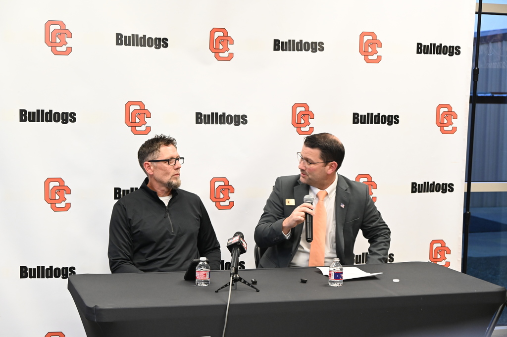 QCISD Superintendent Dr. Casey Nichols talks with new AD Kevin Reaves at a press conference