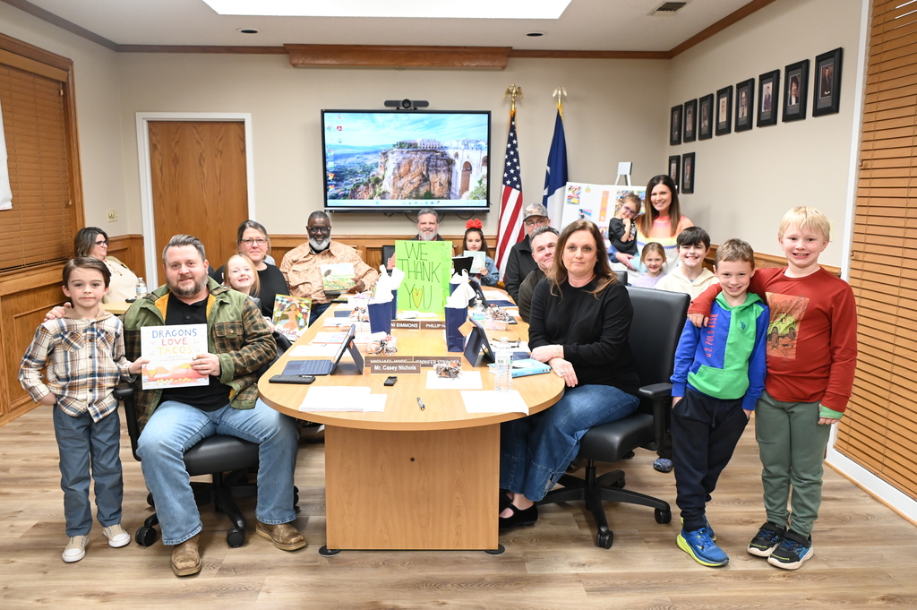 QCISD School Board with JKH students and books to be donated to the library in their honor