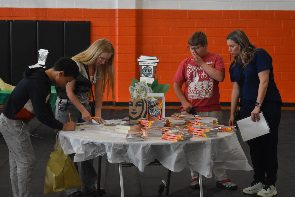 Students checking out science fiction book choices
