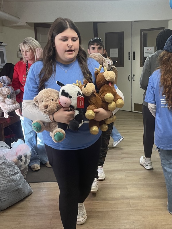 student with stuffed animals