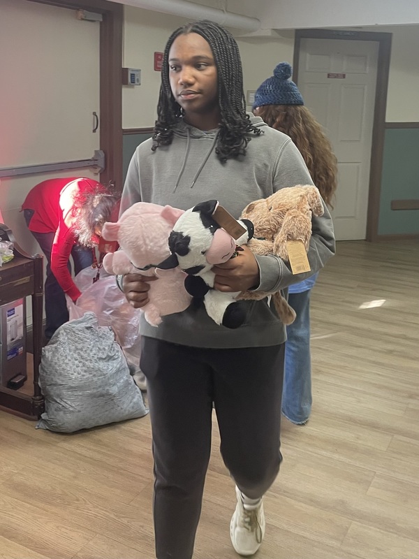 student with stuffed animals