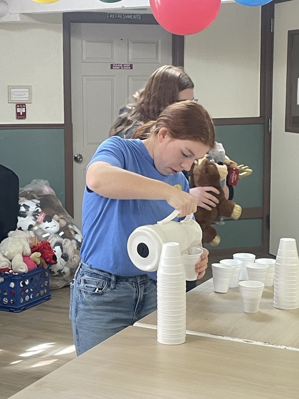 student pouring cocoa