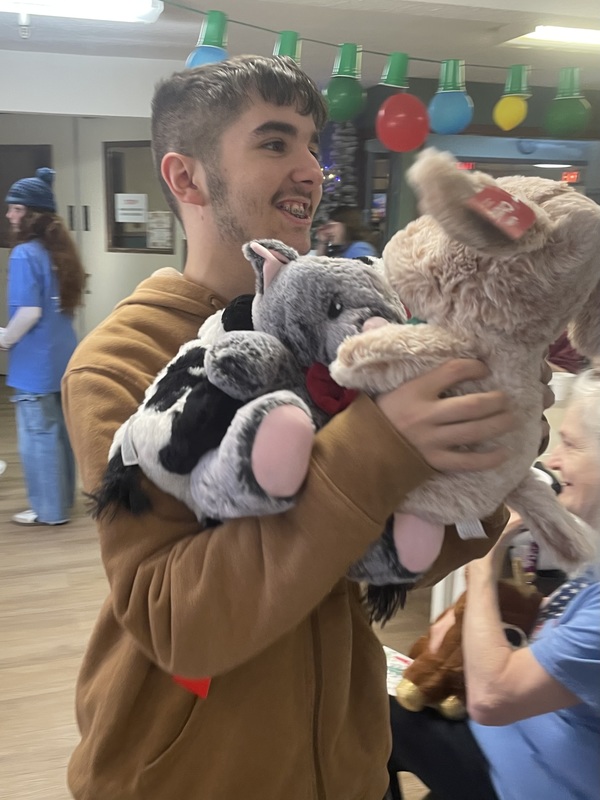 student with stuffed animals