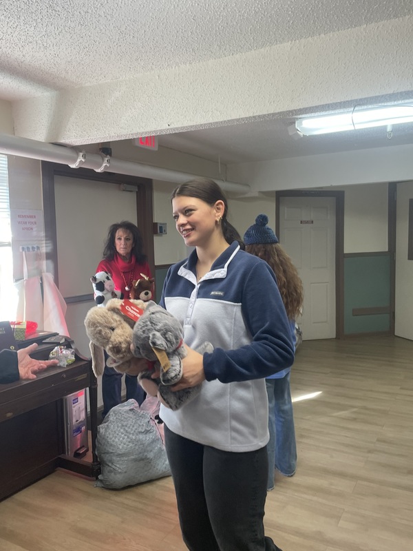 student with stuffed animals