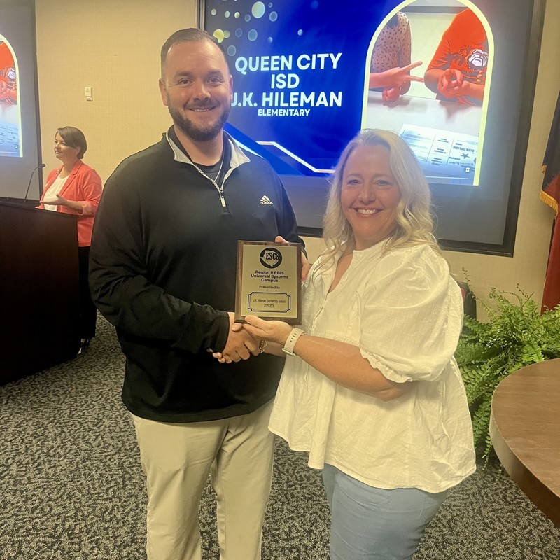 JKH Assistant Principal accepting the plaque for JKH's exemplary implementation of the PBIS program at Region 8 Service Center