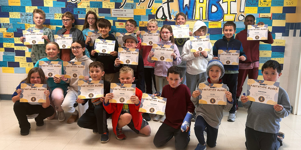 Students stand in group with certificates.