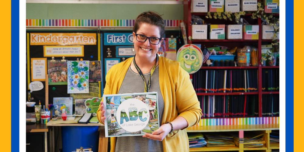 Jen Spath holds book she helped write and illustrate.