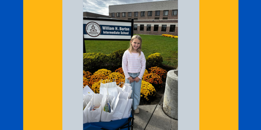 Emery Leo stands in front of the WHBI with care kits.