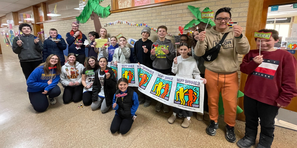 Students stand in QMS hallway.