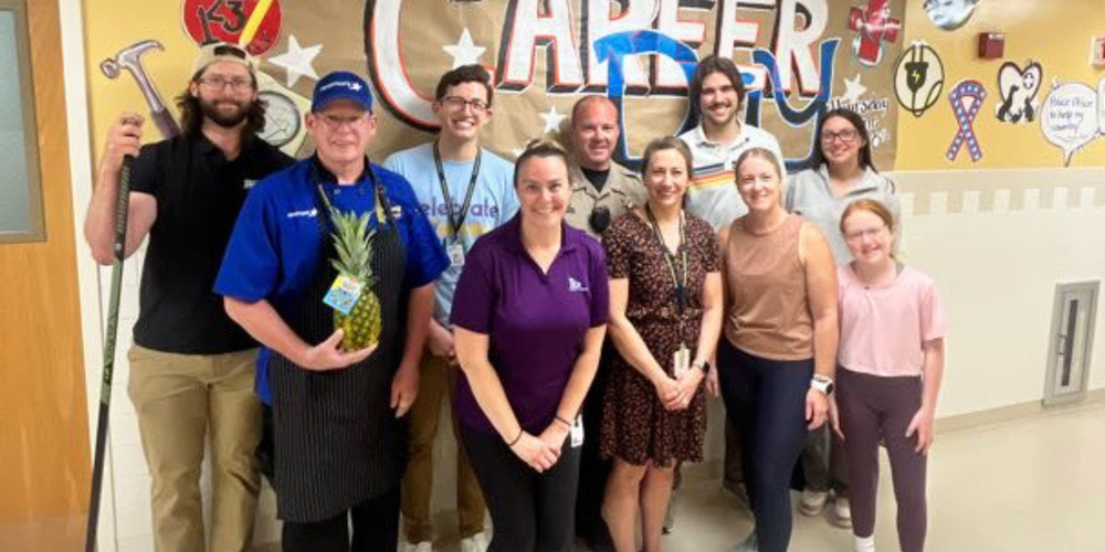 Professionals stand for photo at Career Day at WHBI.