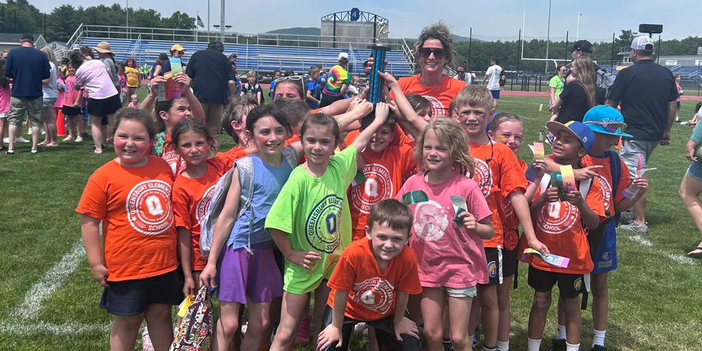 Students hold Field Day trophy.