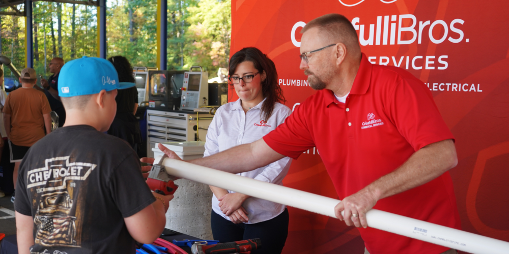 Student cuts pipe during CTE Day.